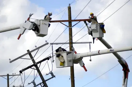 Linemen work to restore power in the aftermath of Hurricane Ida in McComb, Miss., on Tuesday, Aug. 31, 2021. (Matt Williamson/The Enterprise-Journal via AP)