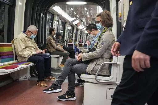 People wearing face masks to protect against COVID-19 ride a subway in Paris, Thursday, June 30, 2022. Virus cases are rising fast in France and other European countries after COVID-19 restrictions were lifted in the spring. With tourists thronging Paris and other cities, the French government is recommending a return to mask-wearing in public transport and crowded areas but has stopped short of imposing new rules. (AP Photo/Michel Euler)