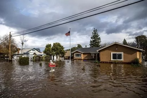 Floodwaters surround homes on Thornton Road in Merced, Calif., as storms continue battering the state on Jan. 10, 2023. Flood risk and climate change are pushing millions of people to move from their homes, according to a new study by the risk analysis firm First Street Foundation. (AP Photo/Noah Berger, File)