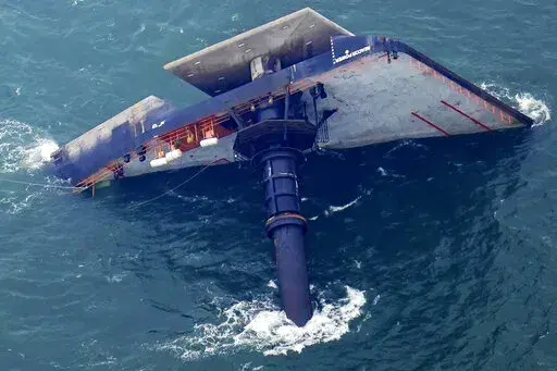 The capsized lift boat Seacor Power is seen seven miles off the coast of Louisiana in the Gulf of Mexico, April 18, 2021. An outage involving a Coast Guard marine warning system and “data gaps” in existing radar systems were contributing factors in last year’s deadly capsizing of an oil industry offshore “lift boat” off of Louisiana’s coast, the National Transportation Safety Board said in a report issued Tuesday, Oct. 18, 2022. (AP Photo/Gerald Herbert, File)