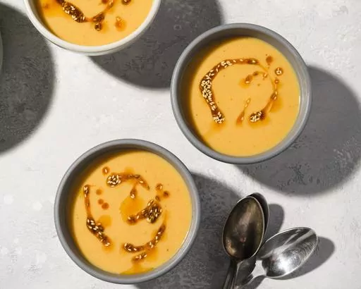 This image released by Milk Street shows a recipe for chickpea and garlic soup with cumin-spiced butter. (Milk Street via AP)