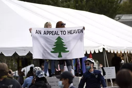People carry an "Appeal To Heaven" flag as they gather at Independence Mall to support President Donald Trump during a visit to the National Constitution Center to participate in the ABC News town hall, Sept. 15, 2020, in Philadelphia. Supreme Court Justice Samuel Alito is embroiled in a second flag controversy, this time over the “Appeal to Heaven” flag, a banner that in recent years has come to symbolize Christian nationalism and the false claim that the 2020 presidential election was stol