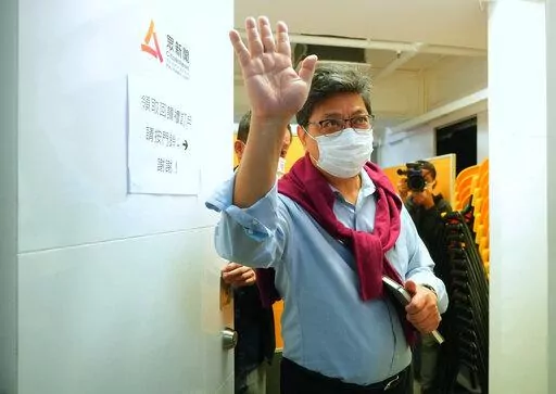 CORRECTS YEAR - Chris Yeung, founder and chief writer of Citizen News waves to journalists after a press conference outside his office in Hong Kong Monday, Jan. 3, 2022. The Hong Kong online news site said Sunday that it would cease operations in light of deteriorating press freedoms, days after police raided and arrested seven people for sedition at a separate pro-democracy news outlet. Citizen News announced its decision in a Facebook post Sunday. It said it would stop updating its site on Jan