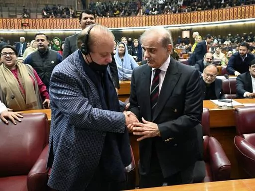 In this photo released by the National Assembly office, Pakistan's newly elected Prime Minister Shehbaz Sharif, foreground right, is congratulated by his elder brother and former Prime Minister Nawaz Sharif following his appointment, at a parliament session, in Islamabad, Pakistan, Sunday, March 3, 2024. Lawmakers in Pakistan's National Assembly elected Sunday Shehbaz Sharif as the country's new prime minister for the second time as allies of imprisoned former premier Imran Khan in parliament sh
