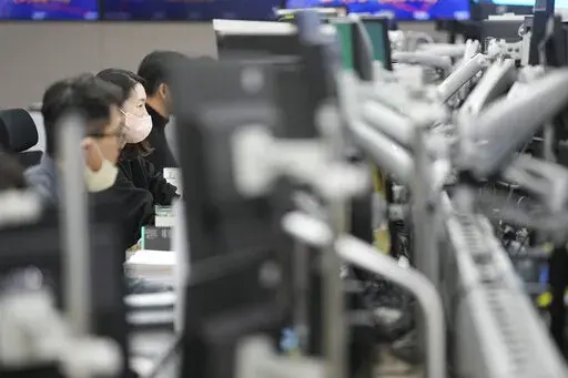 Currency traders watch computer monitors at a foreign exchange dealing room in Seoul, South Korea, Wednesday, Feb. 1, 2023. Asian stock markets were higher Wednesday after Wall Street rose ahead of what traders hope will be the last Federal Reserve interest rate hike for some time. (AP Photo/Lee Jin-man)