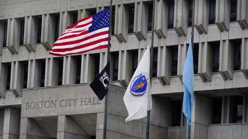 The American flag, the Commonwealth of Massachusetts flag, and the City of Boston flag, from left, fly outside Boston City Hall, Monday, May 2, 2022, in Boston. A unanimous Supreme Court has ruled that Boston violated the free speech rights of a conservative activist when it refused his request to fly a Christian flag on a flagpole outside City Hall. Justice Stephen Breyer wrote for the court Monday that the city discriminated against the activist because of his "religious viewpoint," even thoug