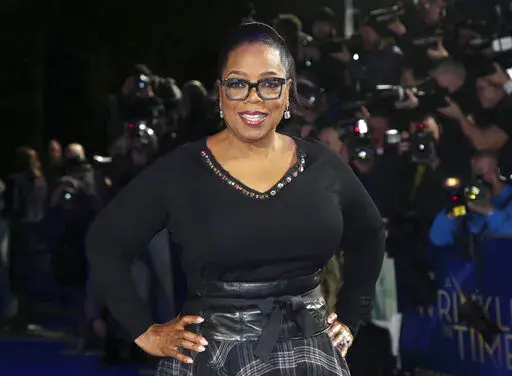 In this March 13, 2018, file photo, actress Oprah Winfrey poses for photographers upon arrival at the premiere of the film "A Wrinkle In Time" in London. Winfrey and the Smithsonian Channel are partnering up to highlight the racial disparities in the healthcare system through a new campaign and documentary. The network revealed on Thursday the Color of Care campaign to create a solution toward health equity. The campaign will follow the premiere of Winfrey’s “The Color of Care” documentary