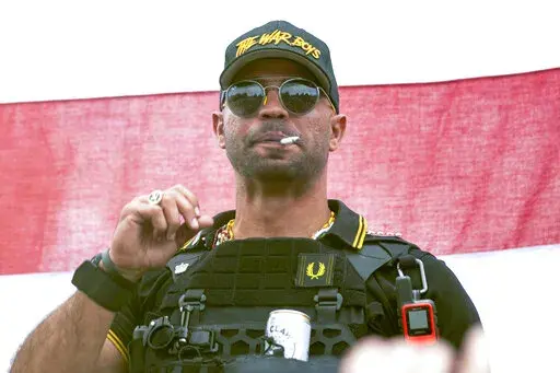In this Sept. 26, 2020, file photo, Proud Boys leader Henry "Enrique" Tarrio wears a hat that says The War Boys during a rally in Portland, Ore.  The leader of the far-right Proud Boys extremist group, Tarrio, was arrested Tuesday on a conspiracy charge for his suspected role in a coordinated attack on the U.S. Capitol to stop Congress from certifying President Joe Biden’s 2020 electoral victory. (AP Photo/Allison Dinner, File)