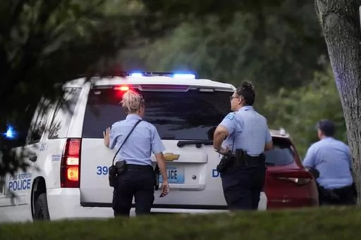 Police take up positions near the scene of a shooting Saturday, Aug. 29, 2020, in St. Louis. Ten years after gaining local control of its police for the first time since the Civil War, the city of St. Louis has even more murders than before — and Missouri lawmakers are again considering a state takeover of the police force. (AP Photo/Jeff Roberson, File)