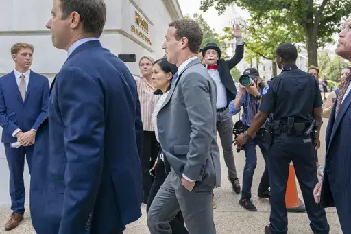 Meta CEO Mark Zuckerberg passes media and a protester as he arrives for a closed-door gathering of leading tech CEOs to discuss the priorities and risks surrounding artificial intelligence, on Capitol Hill in Washington, on Sept. 13, 2023. (AP Photo/Jacquelyn Martin, File)