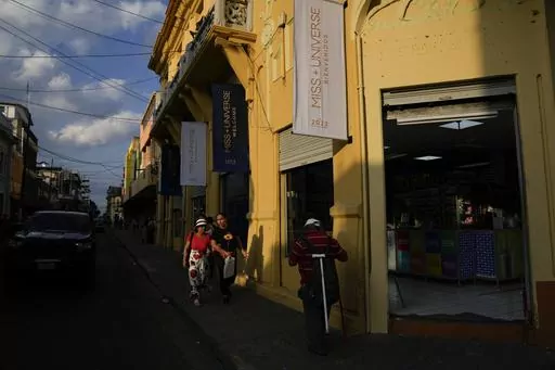 Banners promoting the Miss Universe Pageant hang from a building in downtown San Salvador, El Salvador, Friday, Nov. 17, 2023. El Salvador hosts the 72nd Miss Universe Beauty Pageant. The pageant is the latest spectacle touted by President Nayib Bukele in his efforts to change the reputation of his historically violence-torn nation. (AP Photo/Moises Castillo)