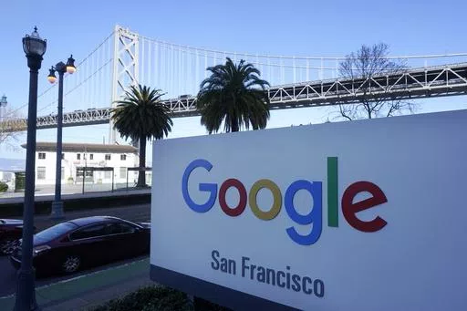 The San Francisco-Oakland Bay Bridge is seen behind a Google sign at the company's office in San Francisco, April 12, 2023. Lawyers for both the Department of Justice and Google are presenting closing arguments in Washington, D.C., Friday, May 3, 2024, to conclude the biggest antitrust case in a quarter century. (AP Photo/Jeff Chiu, File )
