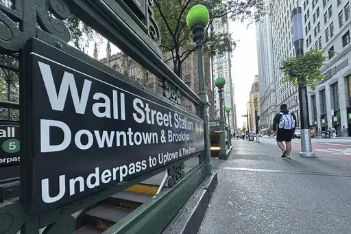 People pass the entrance for the Wall Street subway station on Tuesday, Sept. 2, 2024, in New York. (AP Photo/Peter Morgan)