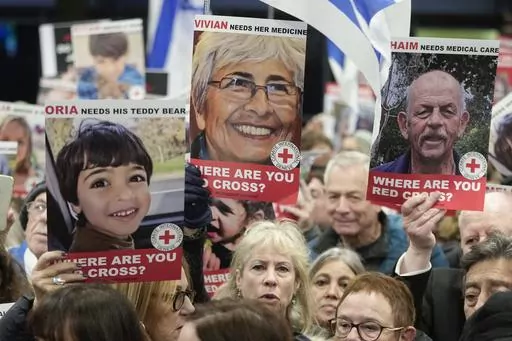 A person holds a poster of Vivian Silver ,top center, as medical staff and health professionals attend a demonstration in front of the International Committee of the Red Cross (ICRC) in London, Thursday, Nov. 9, 2023, calling for an immediate intervention in the case of the hostages kidnapped from Israel on Oct. 7. Vivian Silver, a Canadian-born Israeli activist who devoted her life to seeking peace with the Palestinians, was confirmed killed in Hamas' Oct. 7 attacks in southern Israel. (AP Phot