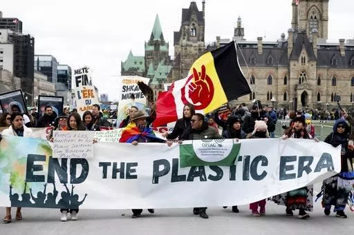 People participate in a March to End the Plastic Era on Parliament Hill in Ottawa, Ontario, on April 21, 2024. (Spencer Colby/The Canadian Press via AP, File)