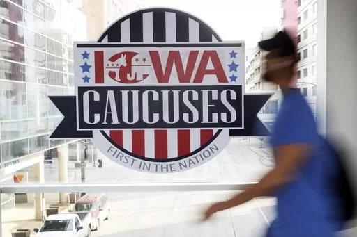 A pedestrian walks past a sign for the Iowa Caucuses on a downtown skywalk, in Des Moines, Iowa, on Feb. 4, 2020. Iowa Republicans have scheduled the party’s presidential nominating caucuses for Jan. 15, 2024, putting the first votes of the next election a little more than six months away. (AP Photo/Charlie Neibergall, File)