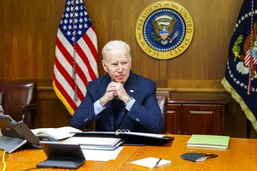 FILE = This image provided by The White House via Twitter shows President Joe Biden at Camp David, Md., Feb. 12, 2022. A new poll finds little support among Americans for a major U.S. role in the Russia-Ukraine conflict. President Joe Biden has acknowledged the growing likelihood of a new war in Eastern Europe will affect Americans even if U.S. troops don’t deploy to Ukraine. Just 26% of Americans say the U.S. should have a major role in the conflict between Russia and Ukraine, according to a 