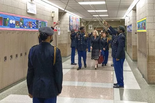 Army Secretary Christine Wormuth is greeted at the Chicago Military Academy as she heads into meetings with young members of the Reserve Officers' Training Corps in Chicago, on Feb. 15, 2023. Army recruiters are struggling to meet enlistment goals, and they say one of their biggest hurdles is getting back into high schools so they can meet students one on one. During three days of back-to-back meetings across Chicago last month, Wormuth met with students, school leaders, college heads, recruiter