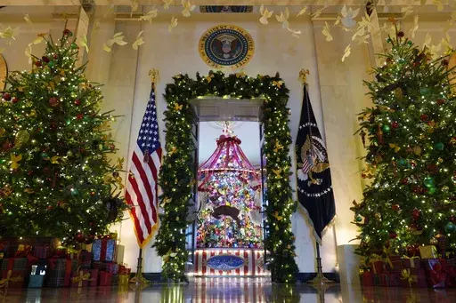 Trees in the Cross Hall frame the doorway to the Blue Room of the White House in Washington, as everything is decorated for the holidays, Monday, Dec. 2, 2024. (AP Photo/Susan Walsh)