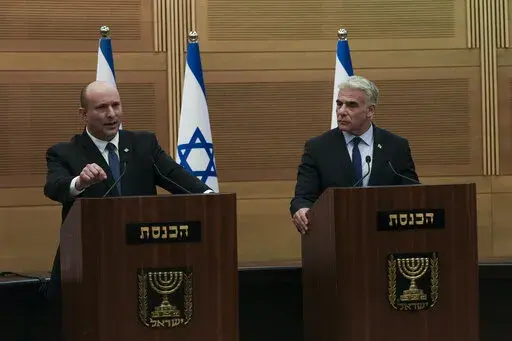 Israeli Prime Minister Naftali Bennett, left, speaks during a joint statement with Foreign Minister Yair Lapid, at the Knesset, Israel's parliament, in Jerusalem, Monday, June 20, 2022. Bennett's office announced Monday, that his weakened coalition will be disbanded and the country will head to new elections. Bennett and his main coalition partner, Yair Lapid, decided to present a vote to dissolve parliament in the coming days, Bennett's office said. Lapid is then to serve as caretaker prime min