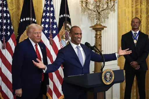 Housing and Urban Development Secretary Scott Turner speaks as President Donald Trump looks on during a reception in the East Room of the White House, Feb. 20, 2025. (Pool via AP, File)