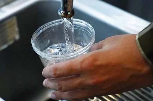 A cup of water is drawn from a faucet at Johnny T's Bistro and Blues, a midtown Jackson, Miss., restaurant and entertainment venue on Sept. 1, 2022. The beleaguered water system in Mississippi's capital city disrupted daily life for 150,000 residents for several days, but Jackson's water is now safe to drink according to the Environmental Protection Agency on Monday, Oct. 31, 2022. (AP Photo/Rogelio V. Solis, File)
