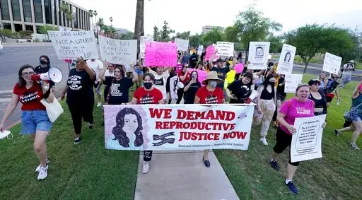 Thousands of protesters march around the Arizona Capitol in protest after the Supreme Court decision to overturn the landmark Roe v. Wade abortion decision Friday, June 24, 2022, in Phoenix. The U.S. Supreme Court ruling overturning Roe v. Wade has legal advocates, prosecutors and residents of red states facing a legal morass created by decades of often conflicting anti-abortion legislation. In Arizona, Republicans are fighting among themselves over whether a 121-year-old anti-abortion law that 