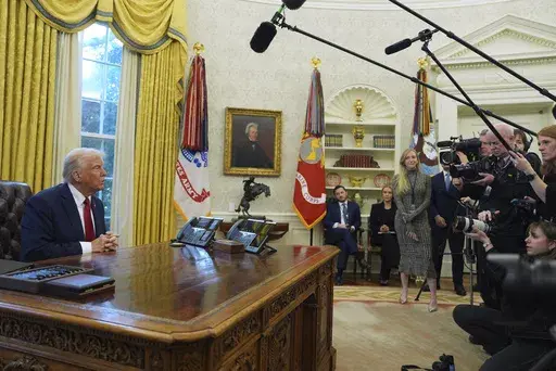 President Donald Trump talks with reporters as he signs executive orders in the Oval Office at the White House, Thursday, Jan. 30, 2025, in Washington. (AP Photo/Evan Vucci)