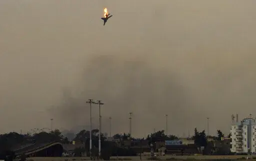 A war plane is shot down over the outskirts of Benghazi, eastern Libya, Saturday, March 19, 2011. On Friday, Feb. 25, 2022, The Associated Press reported that footage of the plane crashing in Libya in 2011 circulated online with false claims that it was captured during Russia's 2022 invasion of Ukraine. (AP Photo/Anja Niedringhaus)
