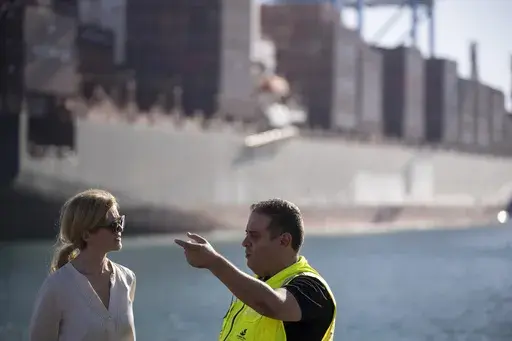 U.S. Agency for International Development Administrator Samantha Power, left, talks to Robt Pellech, manager of the containers department of Ashdod port as they visit the area where cargo ships arrive, carrying humanitarian aid for Gaza Strip, in Ashdod, Israel, Thursday, July 11, 2024. (AP Photo/Leo Correa)