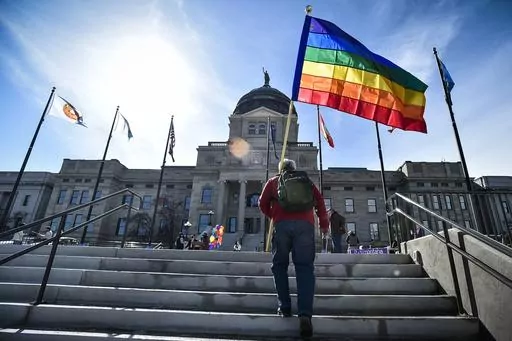 Demonstrators gather on the steps of the Montana state Capitol protesting anti-LGBTQ+ legislation in Helena, Mont., March 15, 2021. A Montana state judge Wednesday, Sept. 27, 2023, has blocked enforcement of a law to ban gender-affirming medical care for minors. (Thom Bridge/Independent Record via AP, File)