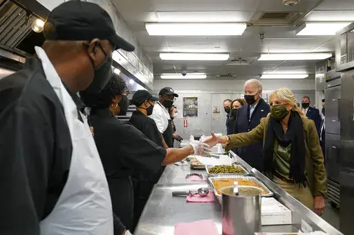 President Joe Biden, first lady Jill Biden, Vice President Kamala Harris, and second gentleman Doug Emhoff, arrive to assemble Thanksgiving meal kits during a visit to DC Central Kitchen in Washington, Tuesday, Nov. 23, 2021. (AP Photo/Susan Walsh)