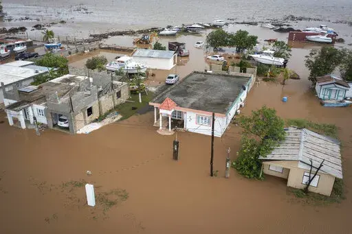 Homes are flooded on Salinas Beach after the passing of Hurricane Fiona in Salinas, Puerto Rico, Monday, Sept. 19, 2022. (AP Photo/Alejandro Granadillo)
