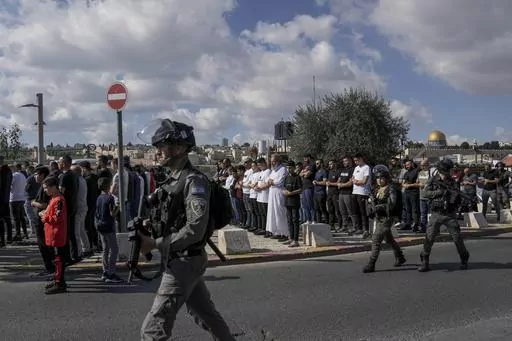 Palestinian Muslim worshipers who were prevented from entering the Al-Aqsa Mosque pray outside Jerusalem's Old City as Israeli forces stand guard on Nov. 17, 2023. ore than 270 Palestinian citizens have been arrested in a crackdown on free speech and political activity since the Hamas attack, according to Adalah, an advocacy organization for Palestinians inside Israel. Palestinian citizens have also reported intimidation, firings and expulsions from universities, as well as surveillance of their