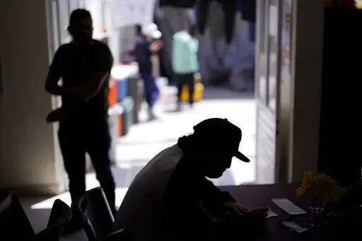 A man from Nicaragua sits at a shelter for migrants Thursday, April 21, 2022, in Tijuana, Mexico. The man is waiting in Mexico for hearings in U.S. immigration court, part of a Trump-era policy that will be argued Tuesday before the U.S. Supreme Court. (AP Photo/Gregory Bull)