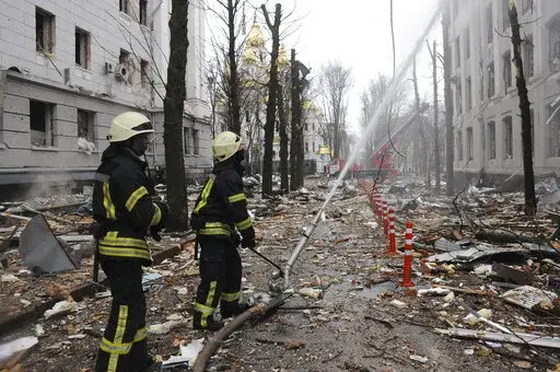 Firefighters extinguish a building of Ukrainian Security Service (SBU) after a rocket attack in Kharkiv, Ukraine's second-largest city, Ukraine, March 2, 2022.  President Joe Biden has called Russia’s war on Ukraine a genocide and accused Vladimir Putin of committing war crimes. But his administration has for weeks grappled with how much intelligence it's willing to give Ukrainian forces trying to stop Putin. (AP Photo/Andrew Marienko, File)