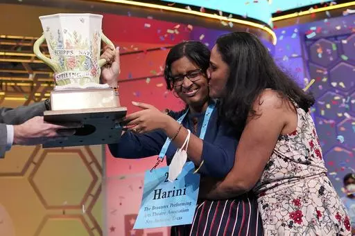 Harini Logan, 14, from San Antonio, Texas, gets a kiss from her mom Rampriya Logan on stage as she celebrates winning the Scripps National Spelling Bee, Thursday, June 2, 2022, in Oxon Hill, Md. Since 1999, 28 of the last 34 Scripps National Spelling bee champions have been Indian American. The experiences of first-generation Indian Americans and their spelling bee champion children illustrate the economic success and cultural impact of the nation’s second-largest immigrant group. (AP Photo/Al