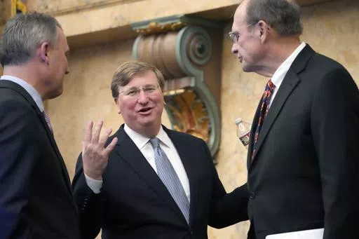 Mississippi Republican Gov. Tate Reeves, center, confers with Mississippi House Speaker Jason White, R-West, left, and Republican Lt. Gov. Delbert Hosemann, after his State of the State address to a joint session of the Mississippi State Legislature, Monday, Feb. 26, 2024, at the state Capitol in Jackson, Miss. Reeves signed legislation Wednesday, May 8, 2024, to change Mississippi's school funding formula beginning July 1, 2024. (AP Photo/Rogelio V. Solis, File)