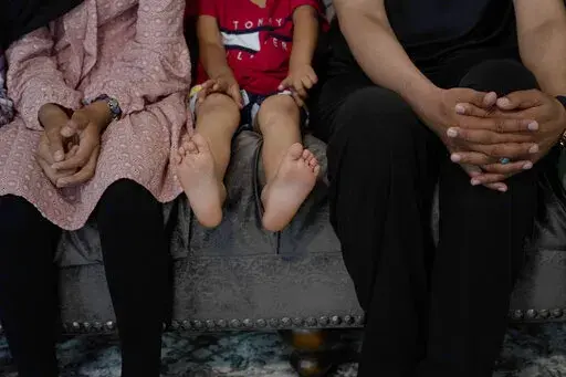 Afghan refugees, who agreed to be photographed on the condition that they not be identified because of security concerns, sit during an interview with an Associated Press journalist in Bensalem, Pa., Thursday, Aug. 26, 2021. (AP Photo/Michael Perez)