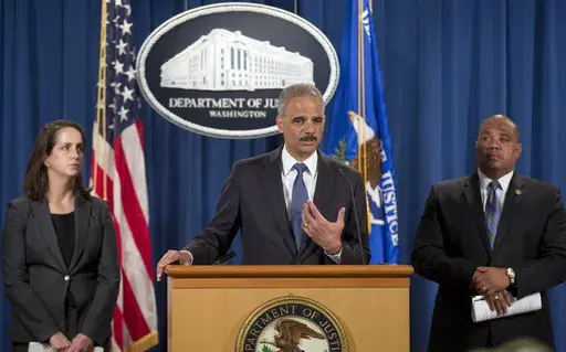 Attorney General Eric Holder, center, speaks during a news conference at the Justice Department in Washington, Thursday, Sept. 4, 2014, to announce the Justice Department's civil rights division will launch a broad civil rights investigation in the Ferguson, Mo., Police Department. Joining Holder are Molly Moran, left, Acting Assistant Attorney General for Civil Rights Division, and Ronald Davis, right, Dir. of the Office of Community Oriented Policing Services (COPS). (AP Photo/Pablo Martinez M
