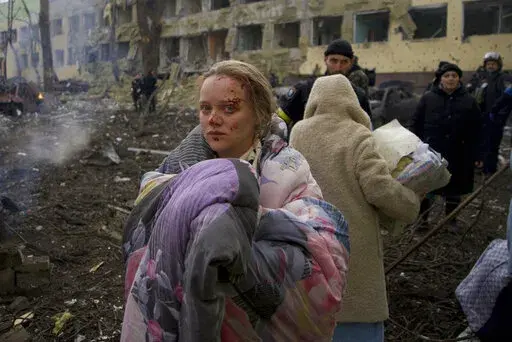 Marianna Vishegirskaya stands outside a maternity hospital that was damaged by shelling in Mariupol, Ukraine, Wednesday, March 9, 2022. Visheirskaya was taken to another nearby hospital where she gave birth the following day to a baby girl she named Veronika. “We were lying in wards when glass, frames, windows and walls flew apart,” she told AP, lying next to her newborn. "We don’t know how it happened. We were in our wards and some had time to cover themselves. Some didn’t.” (AP Ph