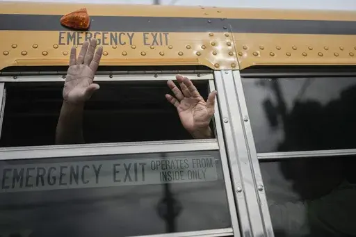 Exiled Nicaraguans released from a Nicaraguan jail wave from a bus after arriving at the airport in Guatemala City, Sept. 5, 2024. (AP Photo/Moises Castillo, File)