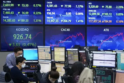 Currency traders watch monitors at the foreign exchange dealing room of the KEB Hana Bank headquarters in Seoul, South Korea, Thursday, March 24, 2022. Stocks slipped Thursday in Asia following a retreat on Wall Street as crude oil prices rose sharply.(AP Photo/Ahn Young-joon)