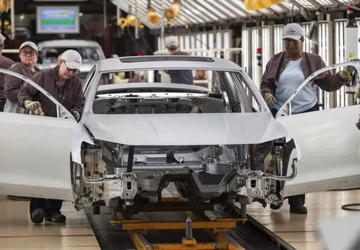 In this Aug. 31, 2017, file photo, workers produce vehicles at Volkswagen's U.S. plant in Chattanooga, Tenn. More than 1,000 workers at the Tennessee factory have signed cards authorizing a vote to be represented by the United Auto Workers union. It's the first plant in the nation to reach that milestone in the UAW’s quest to organize more than a dozen nonunion factories. The union says in a statement Thursday, Dec. 7, 2023 that the workers signed on in less than a week. (AP Photo/Erik Schelzi
