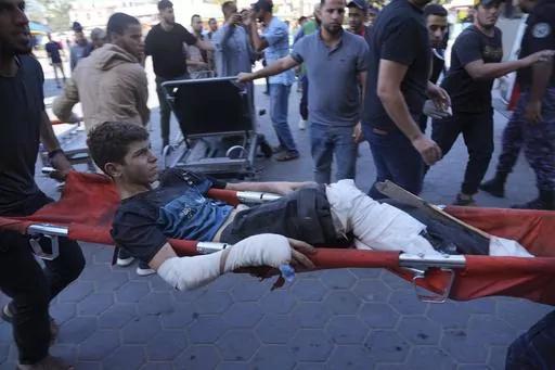 A Palestinian wounded in Israeli bombardment is brought to a hospital in Deir al-Balah, south of the Gaza Strip, Oct. 17, 2023. (AP Photo/Hatem Moussa, File)