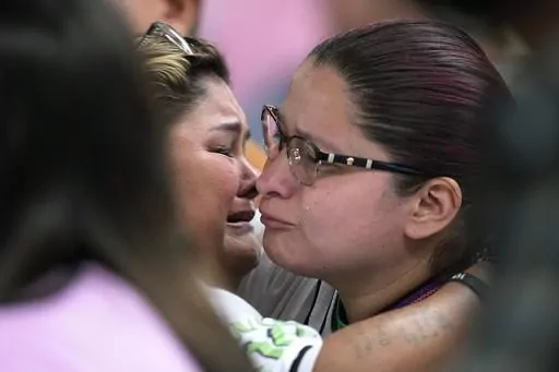 Felicia Martinez, left, and Evadulia Orta, right, both whose children were among 19 children killed in the massacre at Robb Elementary, embrace after speaking at a special city council meeting in Uvalde, Texas, Thursday, March 7, 2024. Almost two years after the deadly school shooting in Uvalde that left 19 children and two teachers dead, the city council met to discuss the results of an independent investigation it requested into the response by local police officers. (AP Photo/Eric Gay)