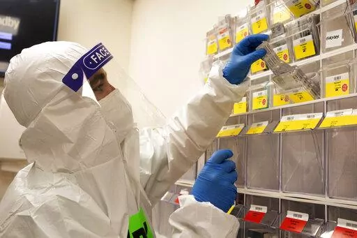 A medical professional pulls patient medication in the coronavirus ward at the Shaare Zedek Medical Center in Jerusalem, Tuesday, Aug. 31, 2021. (AP Photo/Maya Alleruzzo)