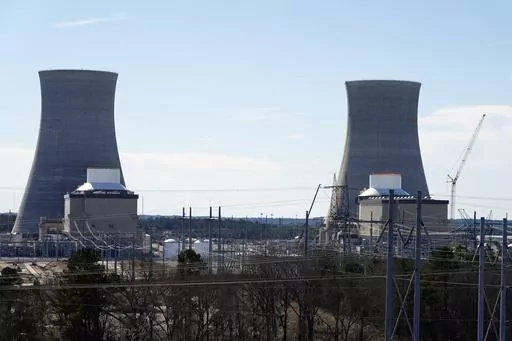 Units 3, left, and 4 and their cooling towers stand at Georgia Power Co.'s Plant Vogtle nuclear power plant, Jan. 20, 2023, in Waynesboro, Ga. Federal nuclear regulators announced on Friday, July 28, that they had cleared Georgia Power and its co-owners to load radioactive fuel into Unit 4, shown at right, the second of two new reactors on the site. (AP Photo/John Bazemore, File)