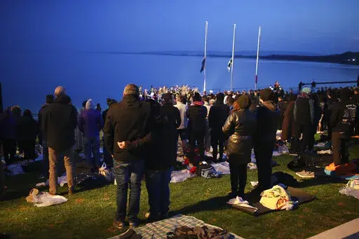 Visitors attend the Dawn Service ceremony at the Anzac Cove beach, the site of the April 25, 1915, World War I landing of the ANZACs (Australian and New Zealand Army Corps) on the Gallipoli peninsula, Turkey, early Monday, April 25, 2022. Travelers from Australia and New Zealand joined Turkish and other nations' dignitaries at the former World War I battlefields for a dawn service Monday to remember troops killed during an unsuccessful British-led campaign that aimed to take the Ottoman Empire o