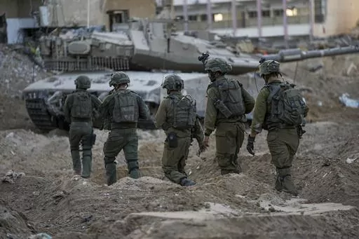 Israeli soldiers are seen during a ground operation in the Gaza Strip, Wednesday, Nov. 8, 2023. Prime Minister Benjamin Netanyahu did not elaborate this week when he said that Israel would maintain indefinite "overall security responsibility" in Gaza once it removes Hamas from power in response to a bloody Oct. 7 cross-border raid by the Islamic militant group. That could complicate any plans to hand governing responsibility to the Palestinian Authority or friendly Arab states, and bog Israel do